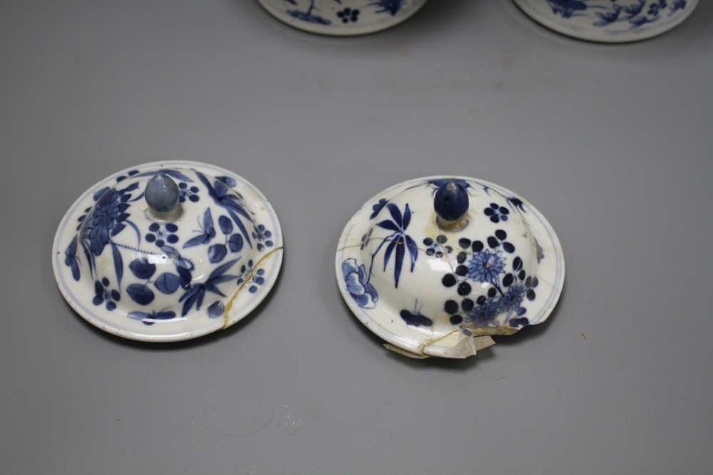 A pair of 19th century Chinese blue and white vases and covers, decorated with birds and flowers, height 23cm